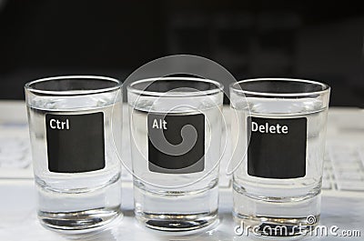 Computer or laptop keyboard with â€œCtr, Alt, Deleteâ€ that are pictured on the three glasses Stock Photo